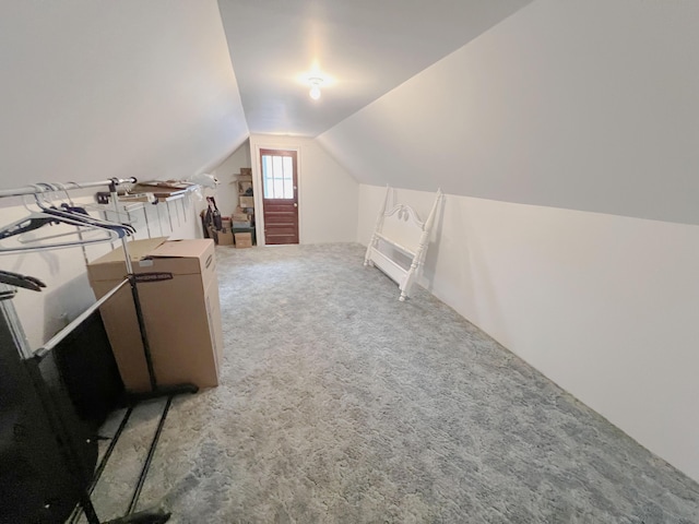 bonus room featuring vaulted ceiling and carpet