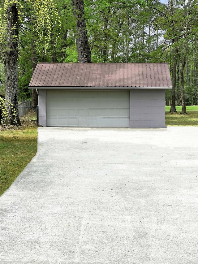 detached garage featuring fence