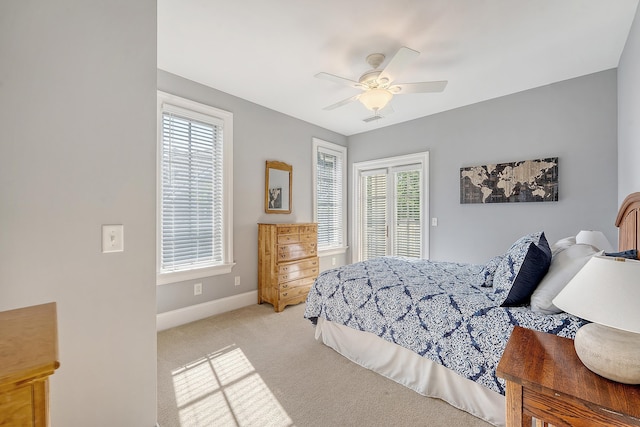 bedroom with light carpet, visible vents, baseboards, access to outside, and ceiling fan
