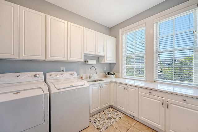 laundry room featuring cabinet space, independent washer and dryer, light tile patterned floors, and a sink