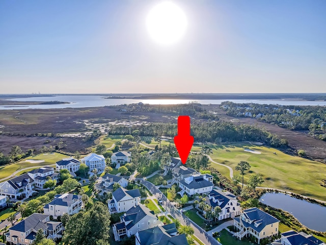 drone / aerial view with view of golf course and a water view