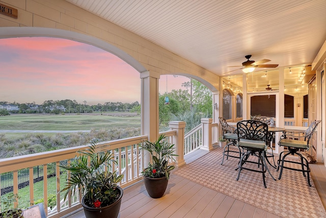 deck at dusk with a ceiling fan