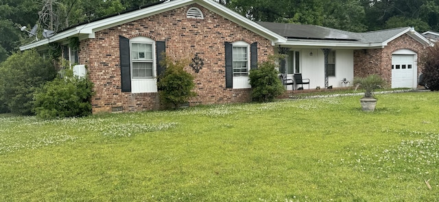 8520 Delhi Rd, North Charleston, SC 29406 - ranch-style house with brick siding, an attached garage, roof mounted solar panels, and a front lawn