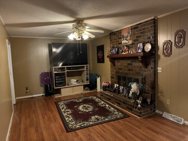 8520 Delhi Rd, North Charleston, SC 29406 - living area with a ceiling fan, crown molding, wood finished floors, a textured ceiling, and a brick fireplace