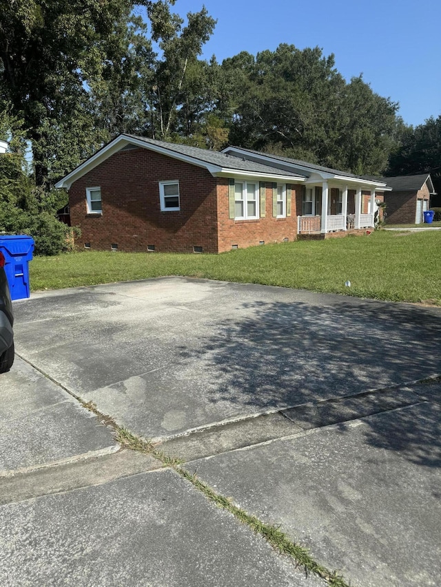 8520 Delhi Rd, North Charleston, SC 29406 - single story home featuring crawl space, a porch, a front lawn, and brick siding