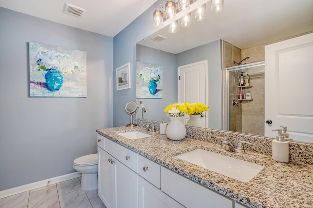 bathroom with baseboards, a sink, toilet, and a shower stall