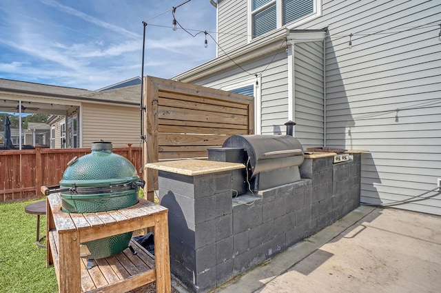 view of patio with fence and grilling area