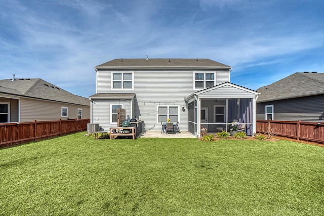 rear view of property featuring a fenced backyard, central AC, a sunroom, a yard, and a patio area