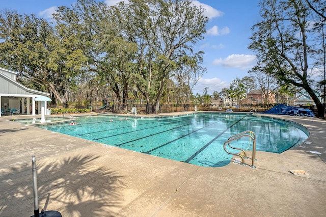 pool with fence and a patio