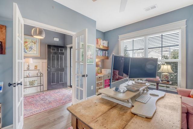 office space with a ceiling fan, visible vents, wood finished floors, and french doors