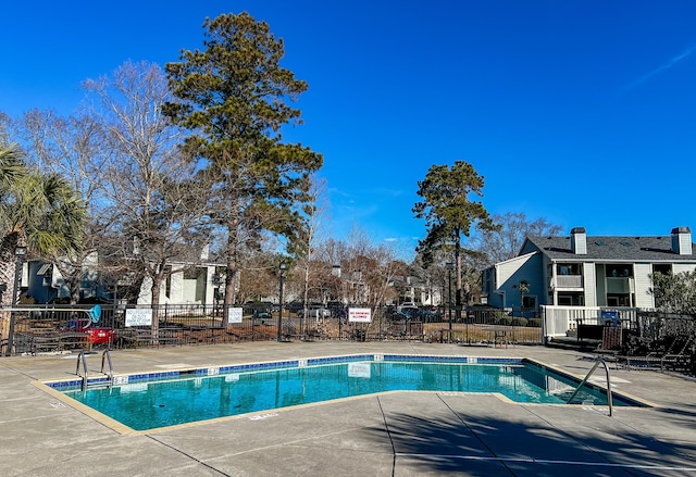 pool featuring a patio area and fence