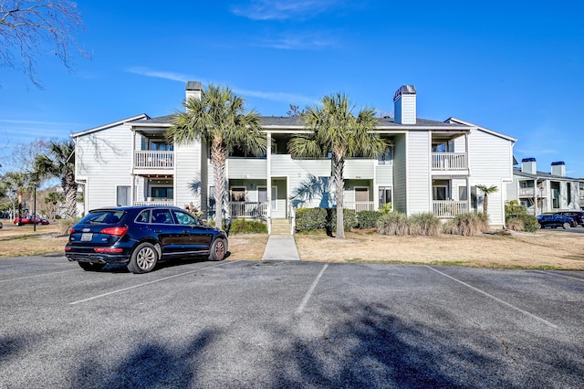 view of property with uncovered parking