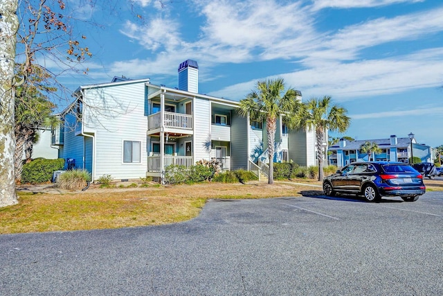 view of property featuring uncovered parking