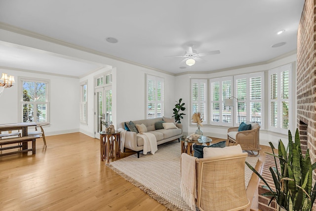 701 Hibbens Grant Blvd, Mount Pleasant, SC 29464 - living area with light wood-style flooring, crown molding, healthy amount of natural light, ceiling fan, and a chandelier