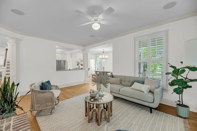 701 Hibbens Grant Blvd, Mount Pleasant, SC 29464 - living area featuring decorative columns, ornamental molding, ceiling fan, light wood finished floors, and a chandelier
