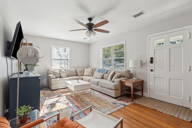 living room featuring ceiling fan and hardwood / wood-style floors