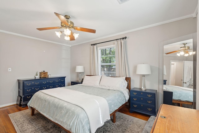 bedroom with light wood-type flooring, ceiling fan, and crown molding