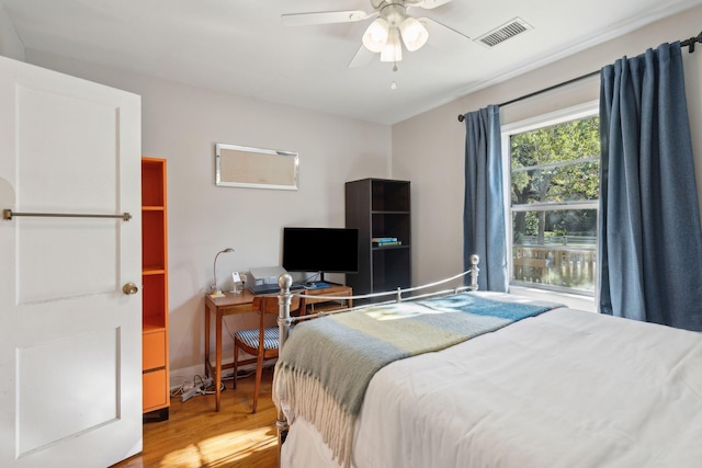 bedroom with ceiling fan and hardwood / wood-style flooring