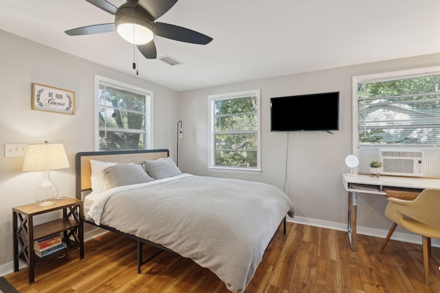 bedroom with ceiling fan, cooling unit, and hardwood / wood-style flooring