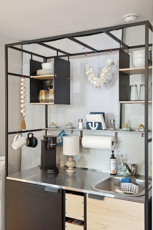 bar featuring stainless steel counters and sink