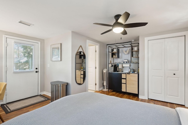 bedroom featuring ceiling fan, a closet, and dark hardwood / wood-style floors