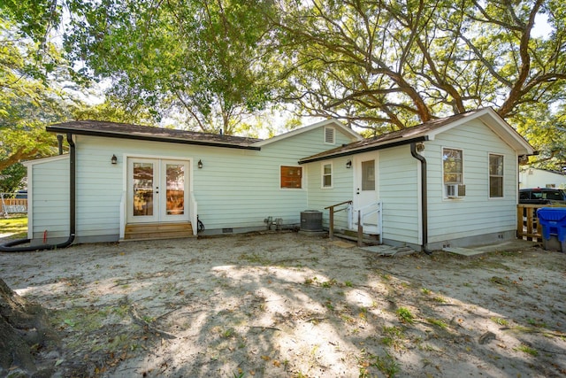 back of house with central AC unit and cooling unit