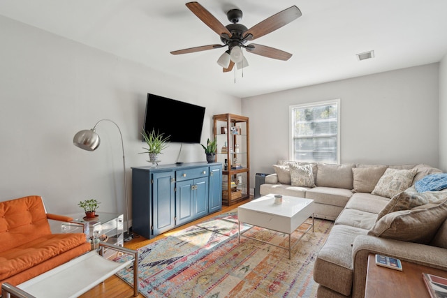 living room featuring ceiling fan and light wood-type flooring