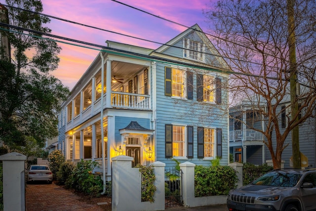 view of front of house featuring a fenced front yard and a balcony