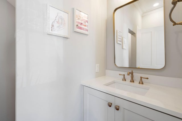 bathroom with recessed lighting, crown molding, and vanity