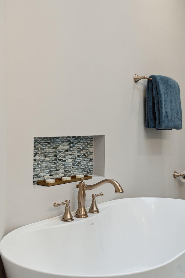 bathroom with tasteful backsplash and a freestanding bath