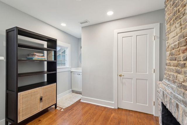 interior space featuring recessed lighting, visible vents, baseboards, and wood finished floors