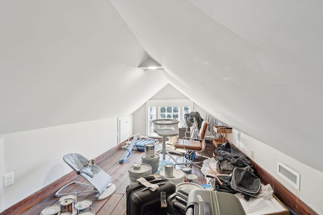 interior space with lofted ceiling and visible vents