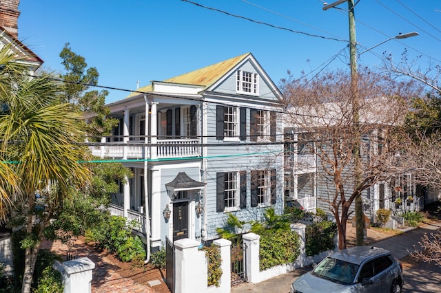 neoclassical home featuring a balcony