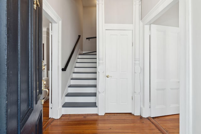 entrance foyer featuring stairs and wood finished floors