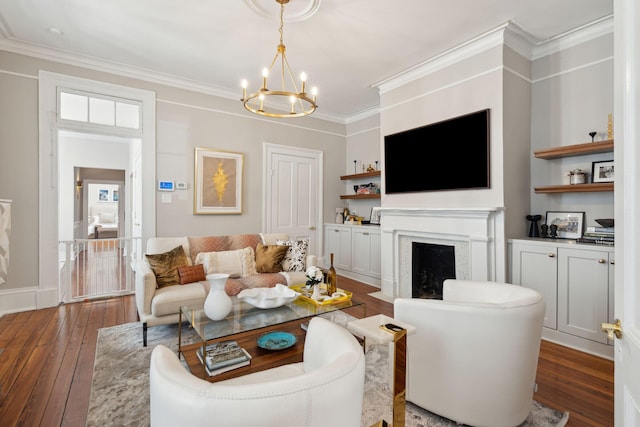 living room featuring a fireplace with flush hearth, ornamental molding, a chandelier, and hardwood / wood-style floors