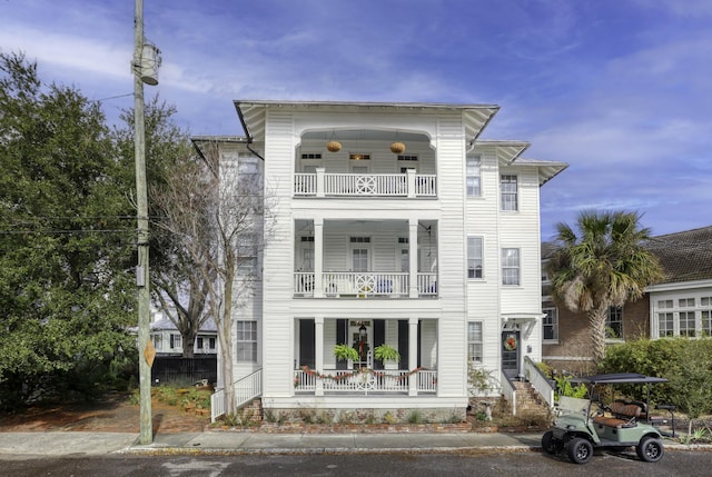 view of front of property with covered porch and a balcony