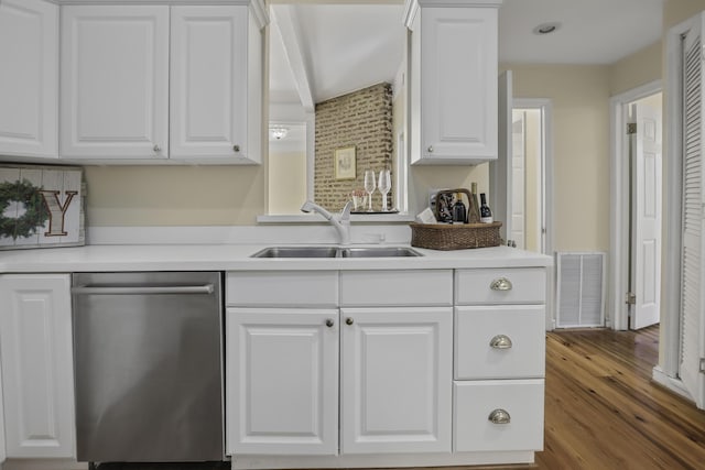 kitchen with dark hardwood / wood-style flooring, white cabinets, sink, dishwasher, and vaulted ceiling with beams