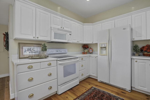 kitchen featuring white cabinets, white appliances, and light wood-type flooring