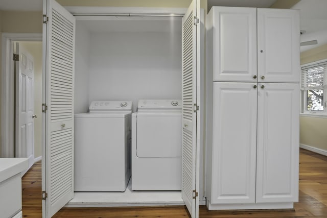 clothes washing area featuring independent washer and dryer and hardwood / wood-style flooring