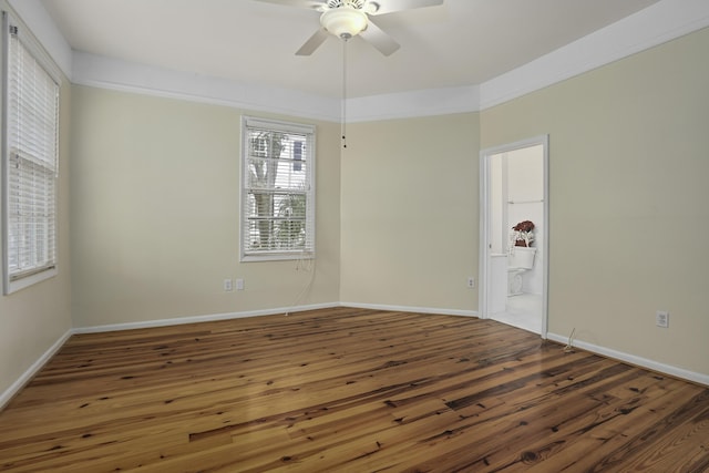 spare room with ceiling fan and dark hardwood / wood-style floors