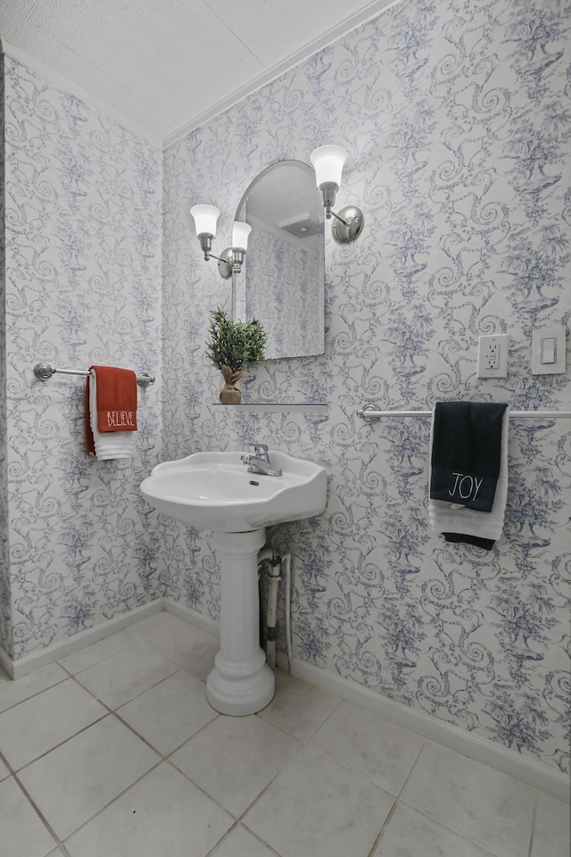 bathroom featuring tile patterned flooring, a textured ceiling, and ornamental molding