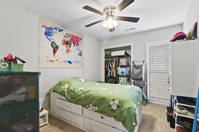 carpeted bedroom with visible vents and a ceiling fan