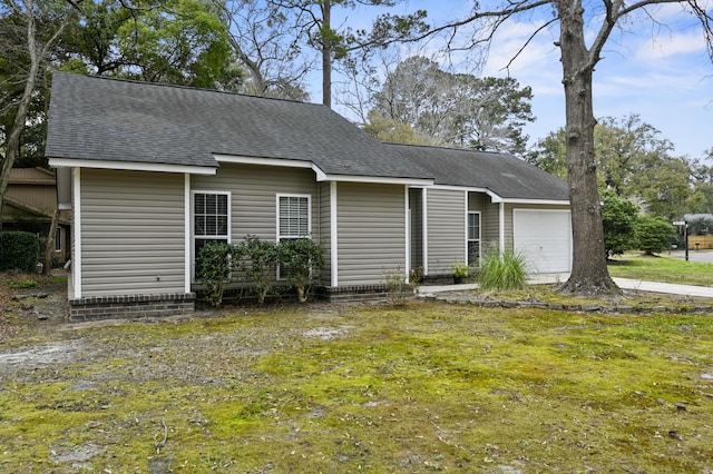 view of front facade with a garage and roof with shingles