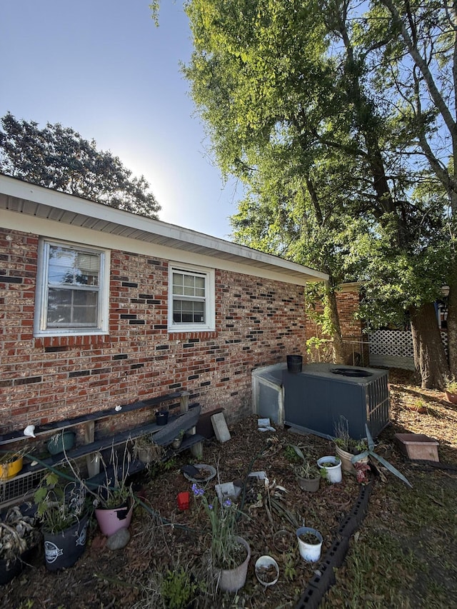 view of side of home with brick siding