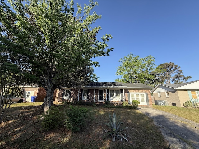 single story home featuring concrete driveway and brick siding