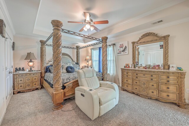 bedroom with ceiling fan, a raised ceiling, ornamental molding, and carpet