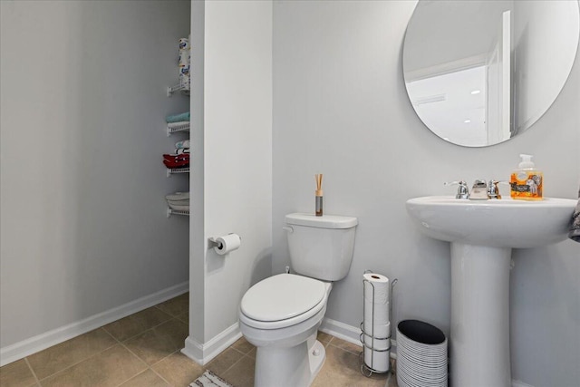 bathroom with tile patterned flooring, sink, and toilet