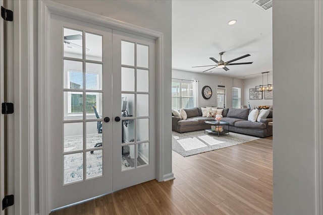 doorway featuring hardwood / wood-style flooring, french doors, and ceiling fan