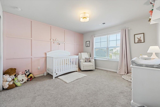 carpeted bedroom featuring a crib