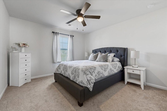 bedroom with ceiling fan and light colored carpet